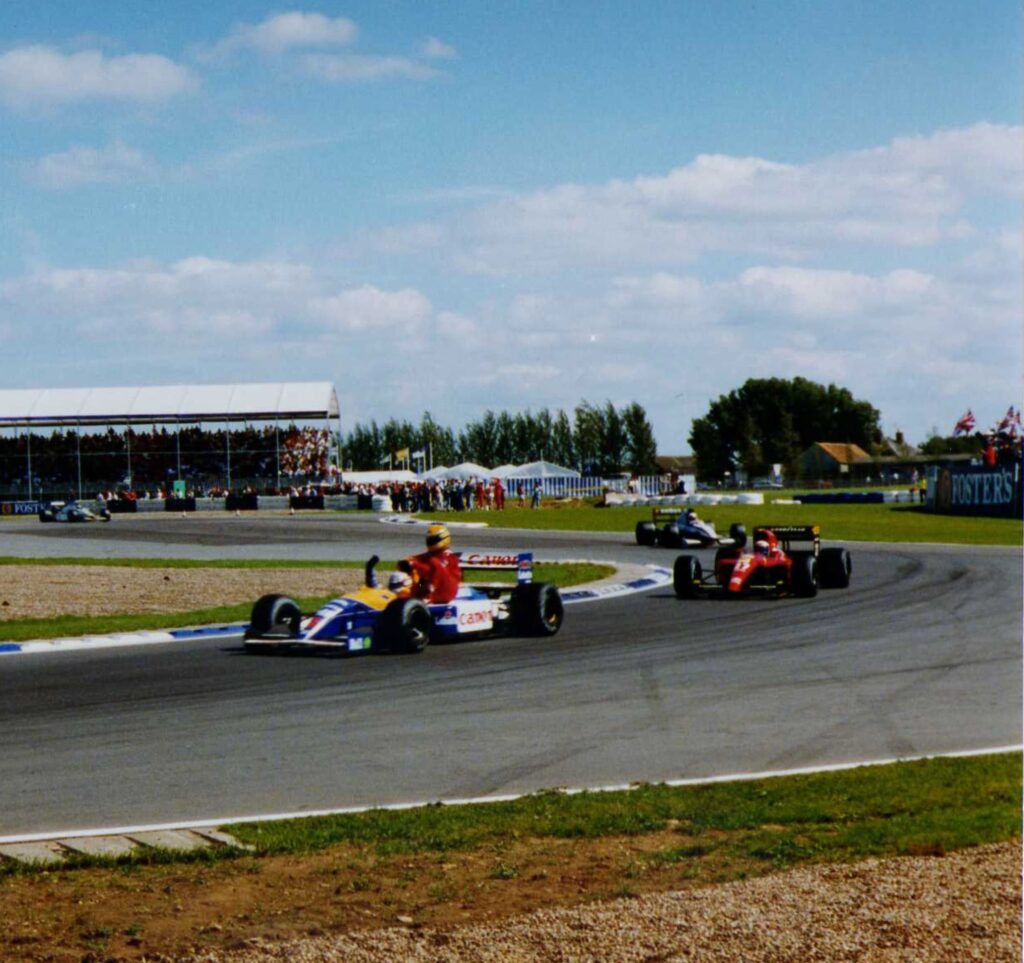 1991 British Grand Prix - Nigel Mansell (Williams) gives Ayrton Senna (McLaren) a lift back to the pits after Senna ran out of fuel on the final lap.