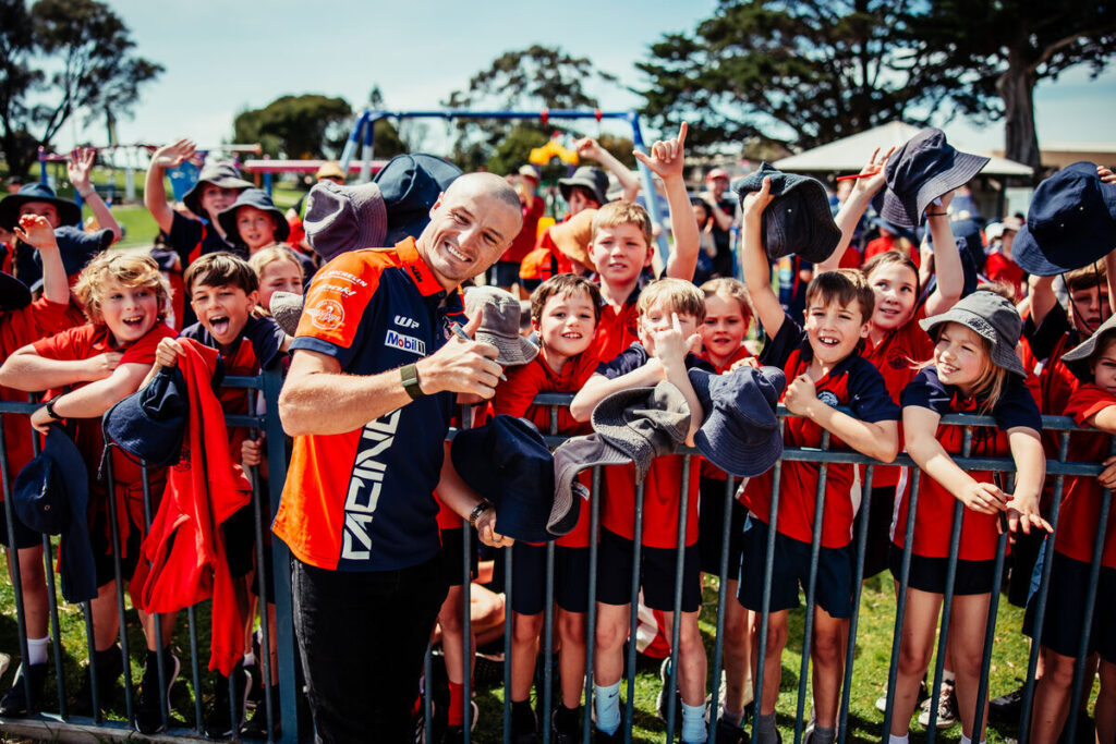 Jack Miller supported by a group of younger fans whilst at Red Bull KTM